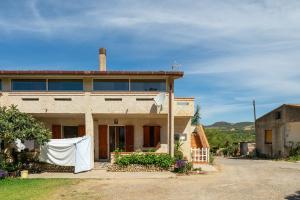 a house with a white sheet on the front of it at Casa Vacanza Iris in Perdaxius
