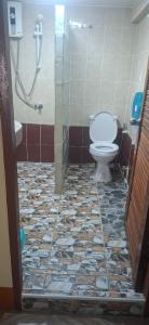 a bathroom with a toilet and a shower at Relax Inn in Ban Phe