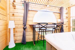 a room with a table and chairs in a cabin at Le Spa des lavandes panoramique in Valensole