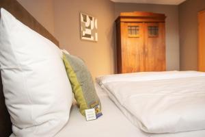 a bedroom with a bed with a pillow and a door at Landgut Stemmen in Stemmen +100 photos