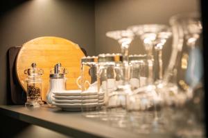a table with glasses and bottles on a shelf at Landgut Stemmen in Stemmen