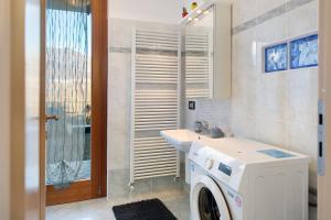 a bathroom with a washing machine and a sink at Studio Apartment Lake and Relax in Gravedona