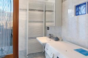 a white bathroom with a sink and a shower at Studio Apartment Lake and Relax in Gravedona +16 photos