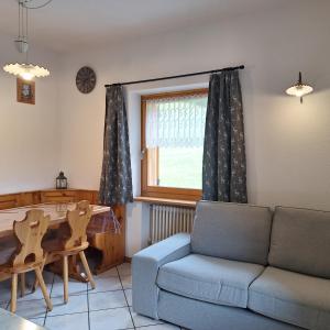 a living room with a couch and a table at Cesa de Conesel in Colle Santa Lucia +68 photos