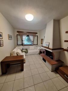 a living room with a couch and a piano at nikol villa elani in Siviri