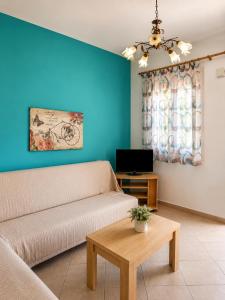 a living room with a couch and a table at Lina's House in Syvota