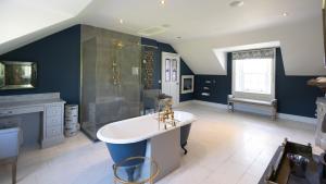 a large bathroom with a tub and a shower at Lissadell on The Beach in Lissadell +43 photos