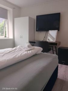a bedroom with a bed and a flat screen tv at Apartment in Stryn in Stryn +53 photos