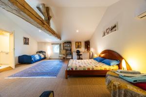 a bedroom with a bed and a room with at Chambres d'hôtes Château Cajus in Saint-Germain-du-Puch