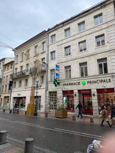 people walking down a street in front of a building at Heritage Suites- Palais des Papes & Pont d'Avignon- Clim in Avignon