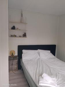 a bedroom with a bed with white sheets at Apartment in Stryn in Stryn