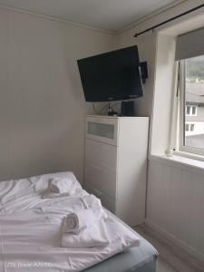 a bedroom with a bed with a flat screen tv at Apartment in Stryn in Stryn