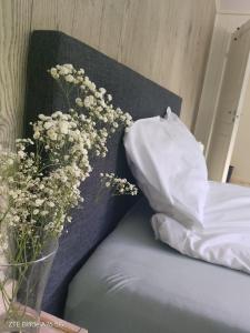 a vase of flowers sitting on a bed with a pillow at Apartment in Stryn in Stryn