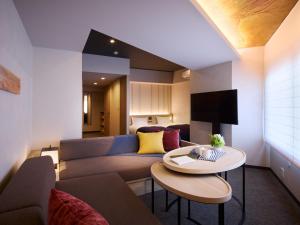 a living room with a couch and a table at Minn Namba South in Osaka