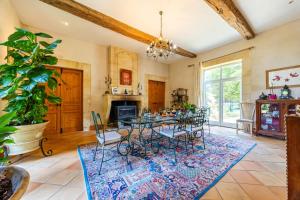 a dining room with a table and chairs and a fireplace at Chambres d'hôtes Château Cajus in Saint-Germain-du-Puch