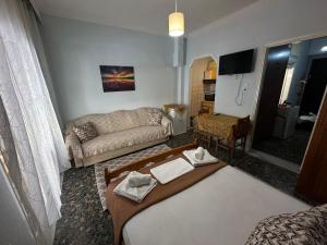 a living room with a couch and a table at LADY E. in Kavála