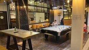 a man is playing a game of pool in a restaurant at Zanya villa & coffee in Da Lat