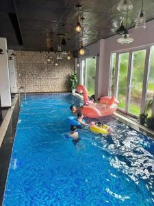 a group of people in an indoor swimming pool at Zanya villa & coffee in Da Lat