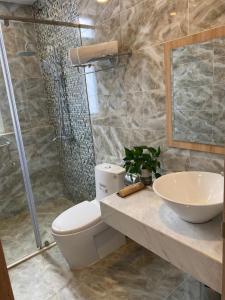 a bathroom with a toilet and a sink and a shower at Zanya villa & coffee in Da Lat