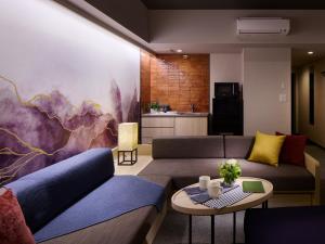 a living room with two couches and a table at Minn Namba South in Osaka