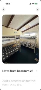 a room with two bunk beds in it at Beach Break Inn in Whitianga