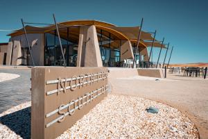 a building with a fence in front of it at The Desert Grace in Solitaire