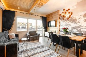 a living room with a table and chairs at Aparthotel Diamond SPA Relax in Białka Tatrzańska