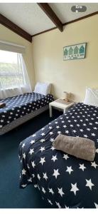 a bedroom with two beds in a room at Beach Break Inn in Whitianga