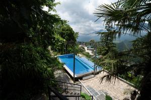 a swimming pool with a view of a mountain at Catcat Garden House in Sapa