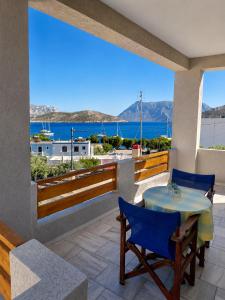 a table and chairs on a balcony with a view of the ocean at Zinovias House in Kalymnos