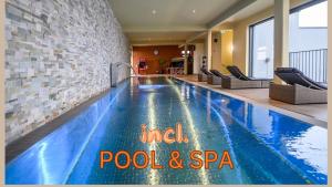 a swimming pool in a hotel room with a pool and spa at GS Hotel in Munich