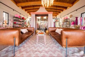 a store with two brown leather couches and a table at The Desert Grace in Solitaire