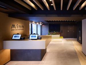 an office lobby with two laptops on a counter at Minn Namba South in Osaka