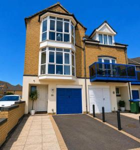 a large brick house with a blue garage at Waterside House in Southampton