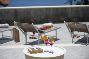 two glasses of wine sitting on a table at Villa CristAl in Praiano