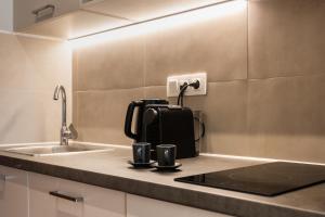 a coffee maker sitting on a counter next to a sink at Au Piree by Calon in Piraeus +132 photos