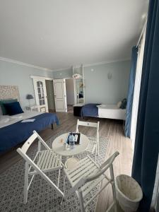 a room with a bed and a table and chairs at Quinta Sao Martinho in Reguengo Grande +219 photos