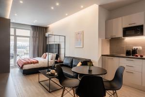 a living room with a couch and a table at Au Piree by Calon in Piraeus