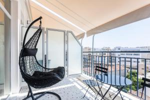 a hammock on a balcony with a view at Au Piree by Calon in Piraeus