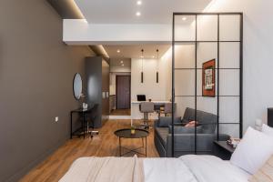 a room with a bed and a couch and a table at Au Piree by Calon in Piraeus