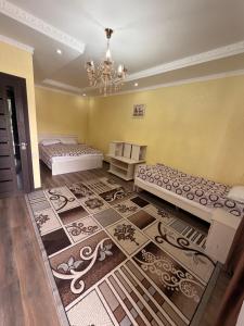 a room with two beds and a chandelier at Yasina in Bosteri +25 photos