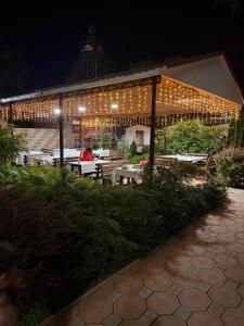 a pavilion with lights on it at night at Yasina in Bosteri