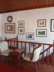 a living room with a table and chairs and a clock at Uşak Sanat Konağı in Uşak