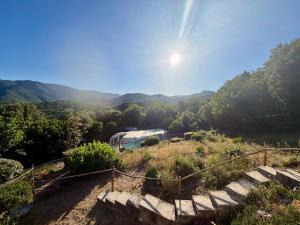 a train on a hill with mountains in the background at Appart 70m2 avec piscine in Saint-Geniès-de-Varensal