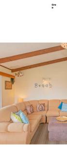 a living room with a couch in a room at Beach Break Inn in Whitianga