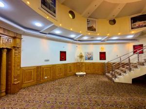 a large room with a staircase in a building at Kite Residence - Secure Stay in Kabul
