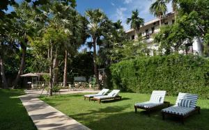 a group of chairs sitting in the grass in front of a building at The Urban in Siem Reap