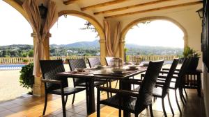 a table and chairs on a porch with a view at El Rafalet in Jávea