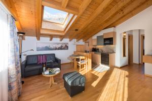 a living room with a couch and a table at Helvetia Apartments in Saas-Fee