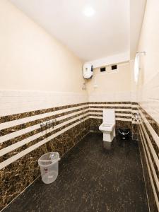 a bathroom with a toilet and a sink at Ananda Homestay in Tawang +7 photos